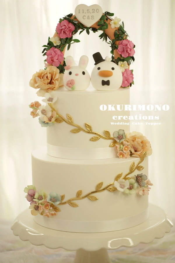 bunny and duck wedding cake topper