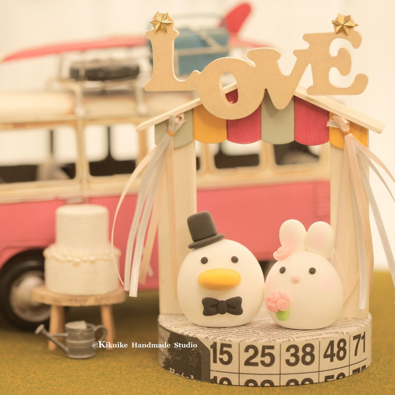 bunny and duck wedding cake topper