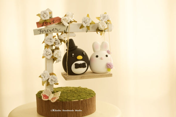 bunny and penguin wedding cake topper