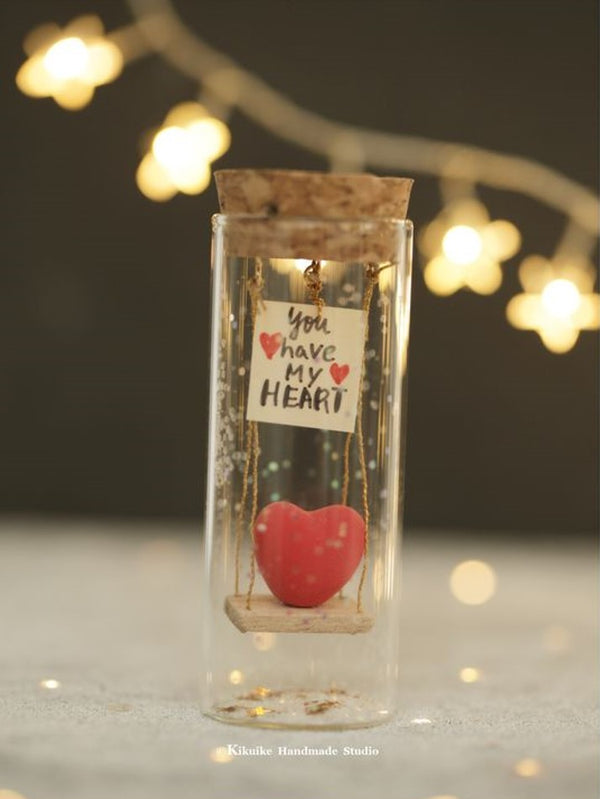 heart with swing, message in bottle